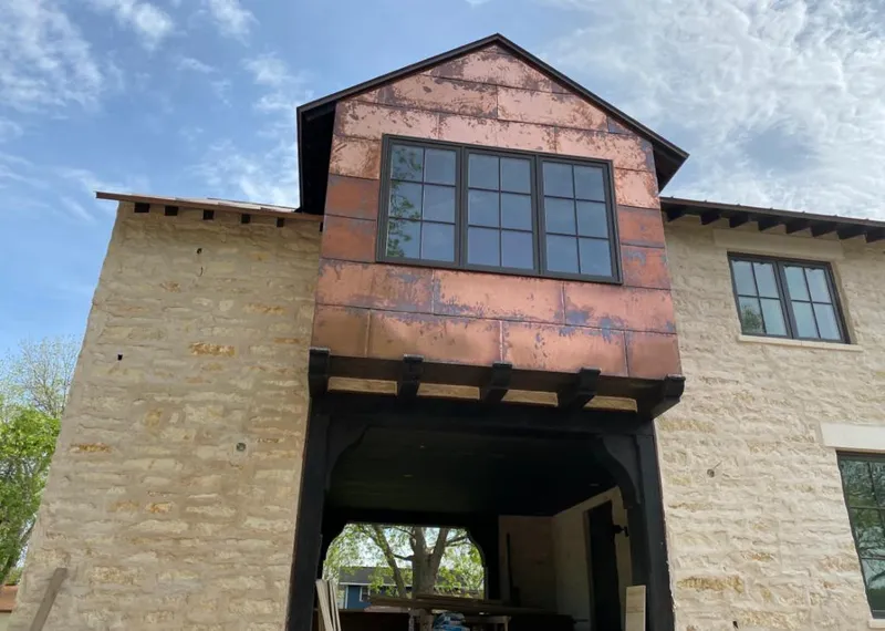 Copper metal panel facade on a stone building for Skylight Installation in Belle Glade