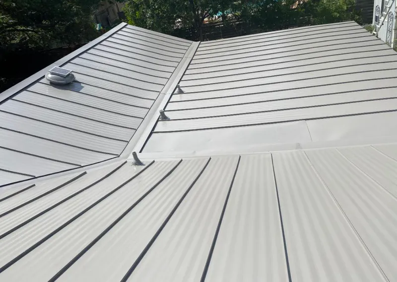 Solar attic fan installed on a metal roof for Roof Ventilation in Belle Glade